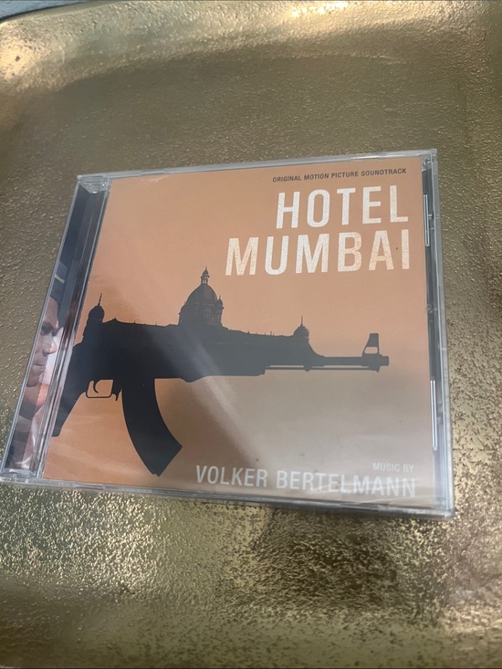 Music by VOLKER BERTELMANN Other - #2103**Hotel Mumbai Original Motion Picture Soundtrack CD - Orange Cover